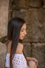 Portrait of a girl with long brown hair outdoors