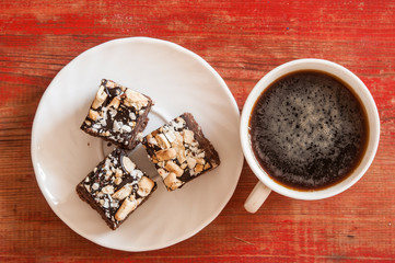 coffee in cup with cookie on wooden table on dark background. Top view.