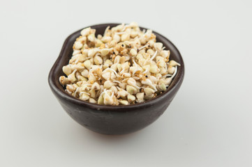 Sprouts of green buckwheat in a bowl. Macro shot. Raw buckwheat. Useful food from buckwheat sprouts for vegetarian food.