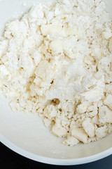 Mixing in a bowl of ingredients butter, cottage cheese and flour for the preparation of cookies