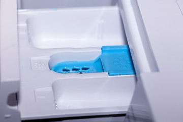 Detail of the compartments to put the detergent softener and bleach in an automatic clothes washer