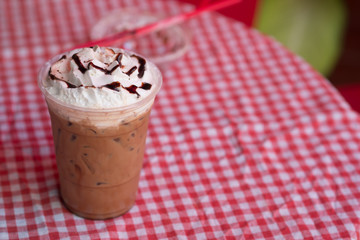 Chocolate sauce and whipped cream on top iced drink