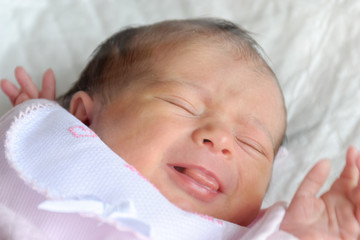 Newborn girl sleeping in the cradle