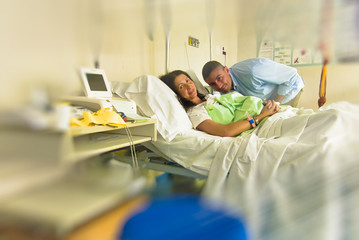 Husband and wife at the hospital after giving birth to their newborn child