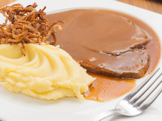 boiled veal in sauce with mashed potatoes