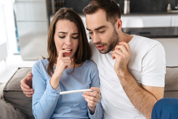 Lovely young couple holdingpregnancy test