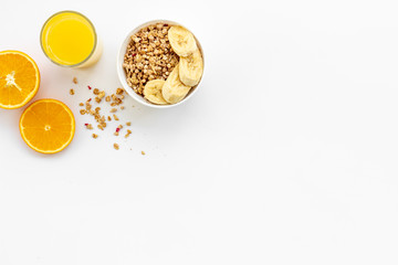 Healthy granola and orange juice for colorful breakfast on white background top view mock-up