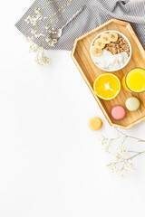 Bright breakfast with granola and orange juice on white background top view mockup