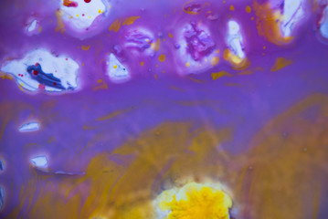 Fluid art psychedelic background. Purple yellow watercolor paint design.