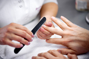 Obraz na płótnie Canvas Close up of nail manicure with emery board
