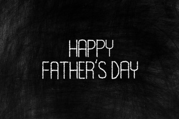 Happy Fathers Day in Chalk Writing on Old Grunge Chalkboard Background.