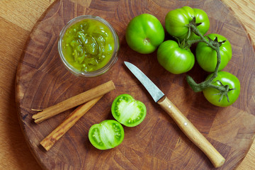 Jam or chutney in a glass jar made of green tomatoes with cinnamon, top view