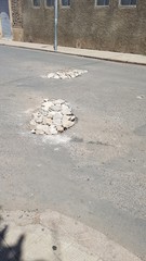 Bad road. Broken asphalt filled up with gravel stones in africa