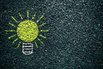 Light Bulb Yellow Chalk Drawing on Asphalt Ground, Suitable for Business Inspiration Concept.