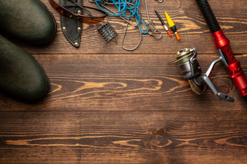 Fishing theme. Frame with rubber boots, rod with reel, fishing buoy, knife and fish string on...