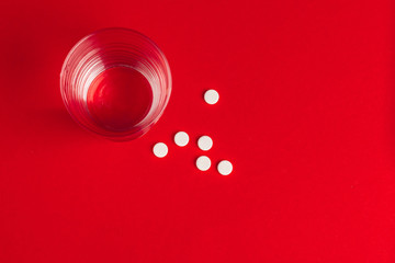 Top view of pharmaceutical medicine pills on red background
