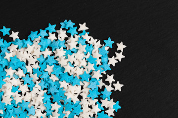 Colored star shaped candy sugar sprinkles as a background