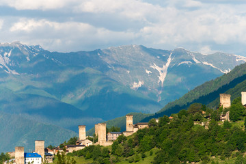 Fototapeta na wymiar Mestia, Georgia - Jun 23 2018: Ancient towers with Mountain village. a famous landscape in Mestia, Samegrelo-Zemo Svaneti, Georgia.