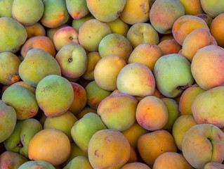 A heap of peaches photographed at the traditional local market of the colonial town of Villa de Leyva, in the Andean mountains of central Colombia.