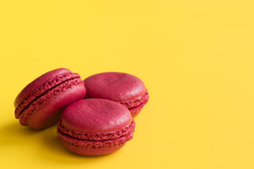 pink macaroons on  yellow background. sweet pink cake