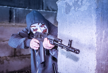 Fototapeta na wymiar Man in mask with a gun