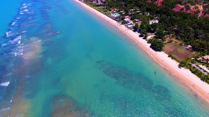 Aerial view of Arraial d’Ajuda Beach, Porto Seguro, Bahia, Brazil. Beauty landscape with several palm trees. Travel destination. Vacation travel. Tropical travel.