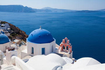 Fototapeta na wymiar Santorini panorama. Mediterranean sea, sky, dome and white houses on coastline