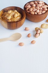 Peanut in wooden bowl on classic wooden table background, peanut butter