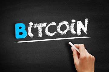 Bitcoin text on blackboard, business concept background