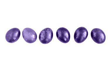 Ultraviolet Easter eggs in a row on isolated white background. Copy space.