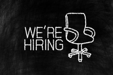We're hiring and Working Chair in Chalk Drawing Style on Old Grunge Chalkboard Background, Suitable for Jobs Concept.