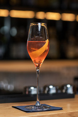 Glass of aperol spritz cocktail long drink close up, summer fresh appetizer, evening meal, dinner.