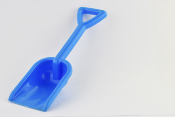 blue toy shovel on white floor