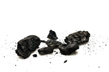 Black burnt firewood with ash on white surface
