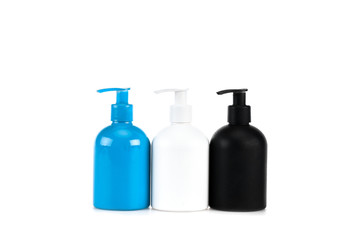 Three cosmetic bottles with sprays isolated on white