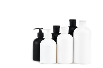 Black and white cosmetic bottles isolated on white