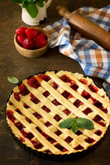 Berry pie summer. Sweet pie, tart with fresh berry strawberries on a rustic kitchen table. Delicious cake with strawberries.