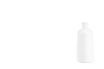 White cosmetic bottle with cap isolated on white