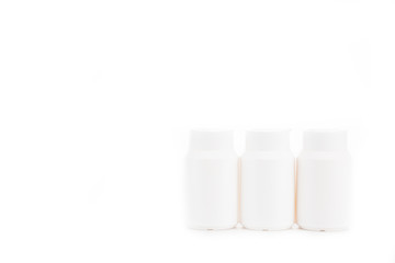 White cosmetic containers with caps isolated on white