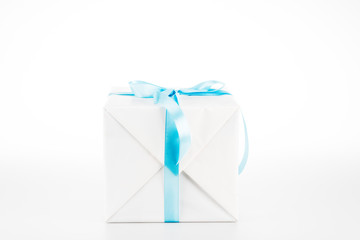 White gift box with blue ribbon on white