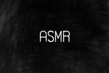 ASMR or Autonomous Sensory Meridian in Chalk Writing on Old Grunge Chalkboard Background.