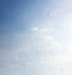Soap bubbles fly in the blue sky