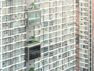 Fototapeta premium Close - up of a modern high condominium and tree at day time