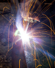 Sparks from welding at a construction site as a background