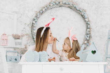 mom and daughter are preparing for Easter