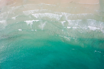 Aerial view, tropical beach, top view of the waves on the beautiful sand beach