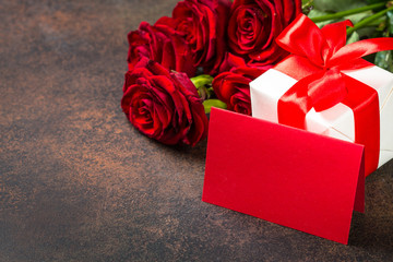 Holiday background with card, present and flowers.