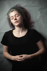 Naklejka premium Beautiful young woman lying on the floor