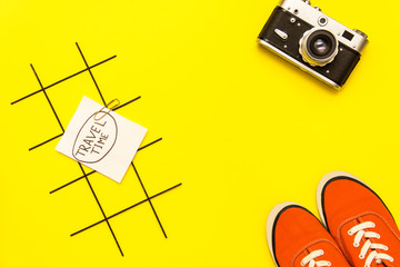 items for rest in hot countries on yellow background. copy space for text in travel advertising.retro camera, sunglasses, orange sneakers.travel time. summer vacation. summer flat lay. top view.