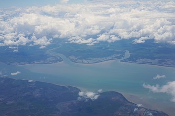 View of the sky and the blue sea from the plane's window